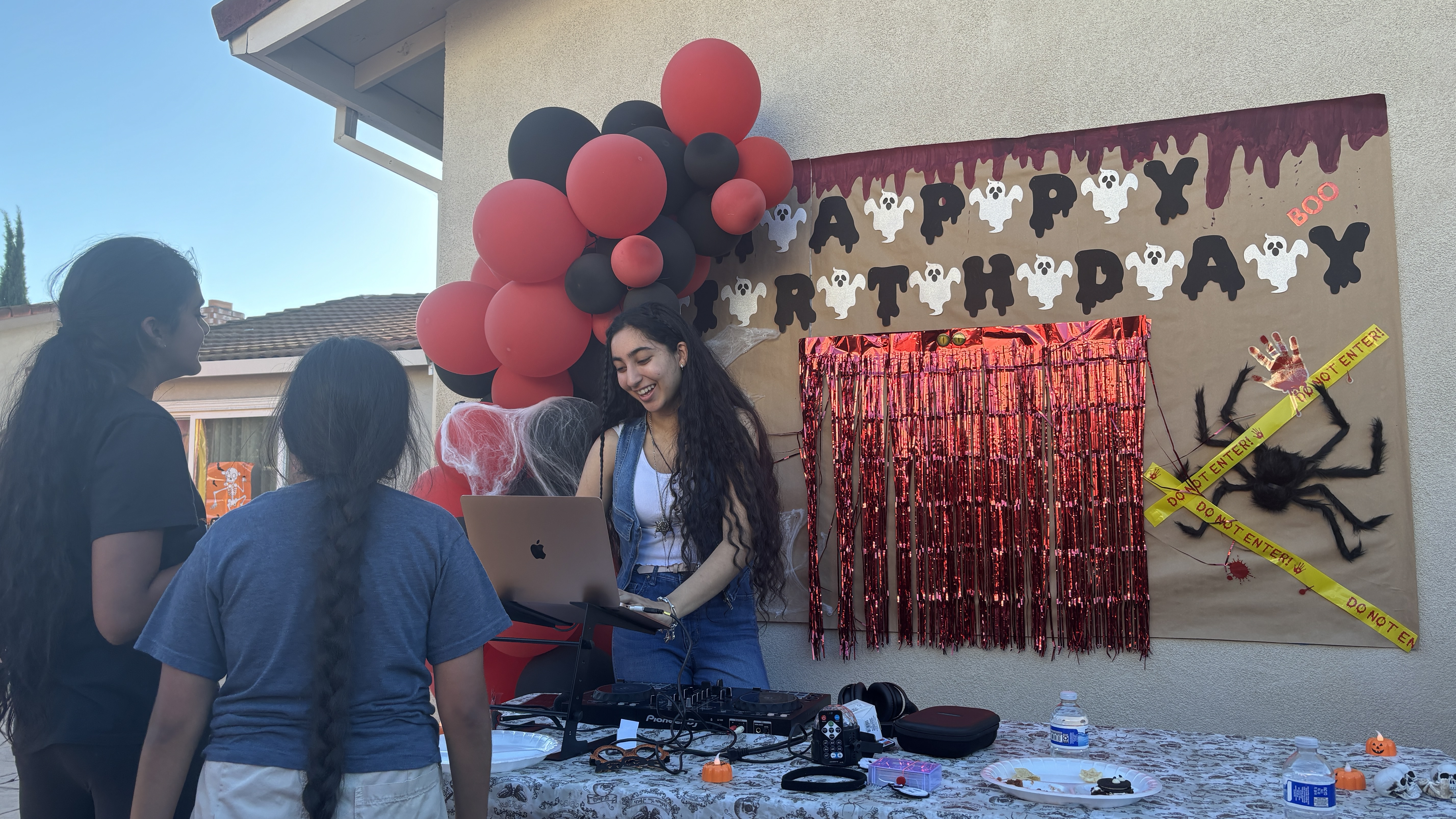 Birthday party setup with balloons and a celebration backdrop